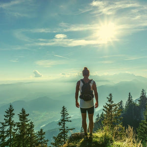 Male hiker basking in the sunshine atop a gorgeous mountain